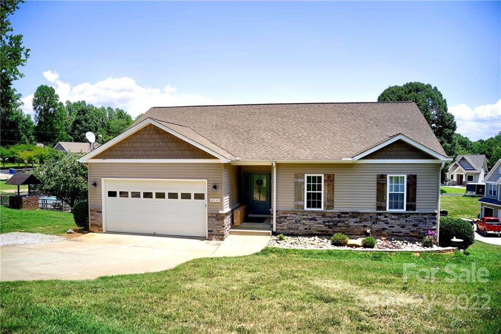 Single-family home for sale with garage and lawn