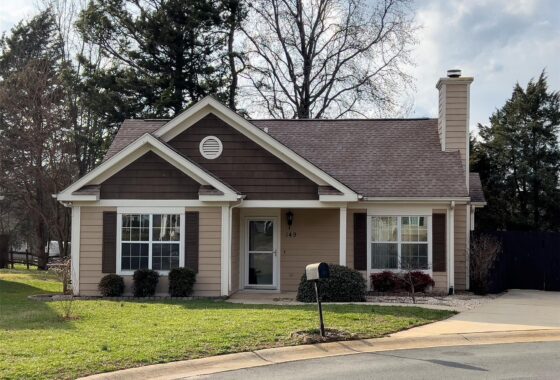 Charming suburban house with front yard and mailbox.