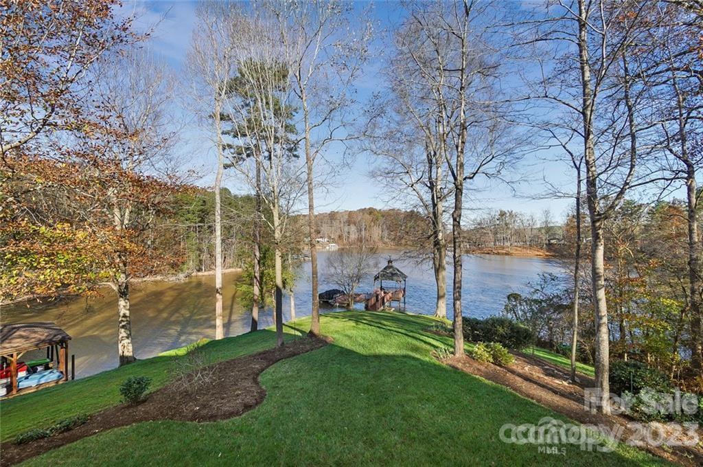 Lakeside view with dock and gazebo in fall.