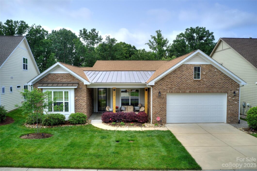 Modern brick house with green lawn and garage.