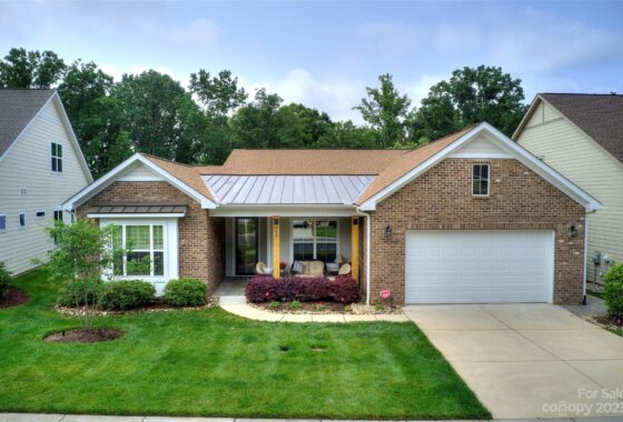 Modern brick house with green lawn and garage.