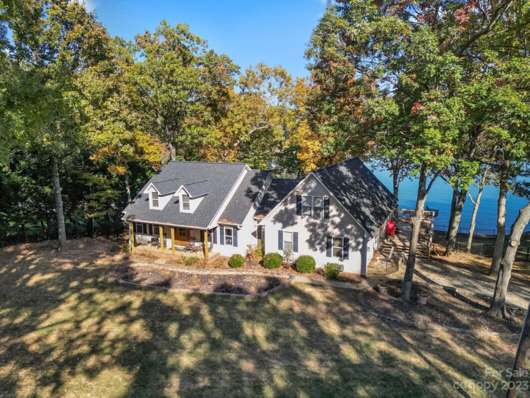 House by lake surrounded by trees