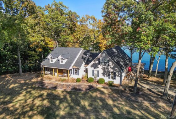 Lakeside house surrounded by trees.