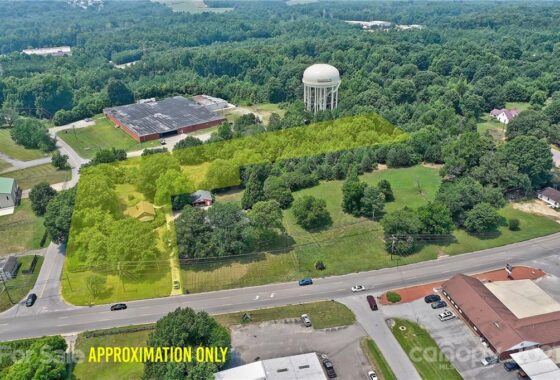 Aerial view of outlined property for sale near water tower.