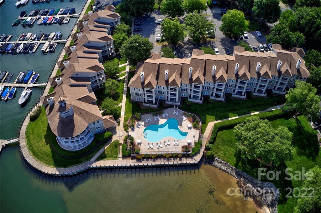 Aerial view of waterfront townhomes and pool area.