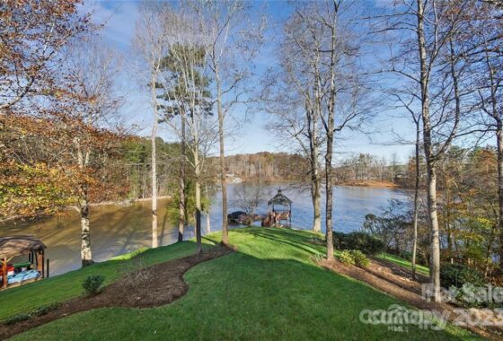 Lakeside property with trees and a gazebo.