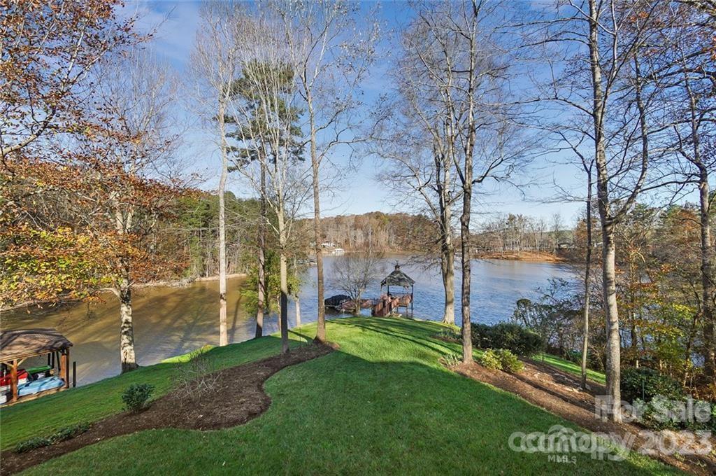 Lakeside backyard with trees and gazebo view
